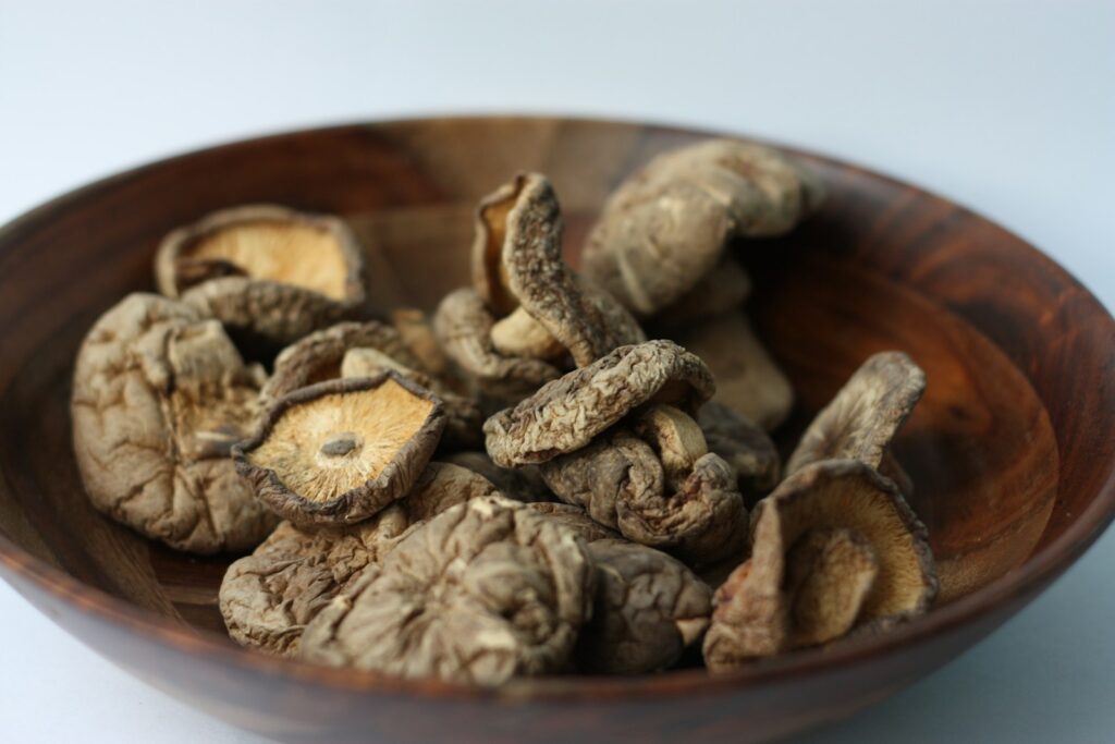 brown mushrooms in brown wooden bowl