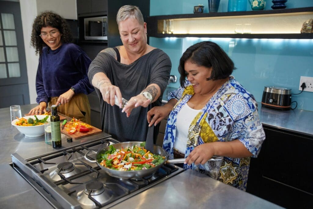 a group of people preparing food in a kitchen