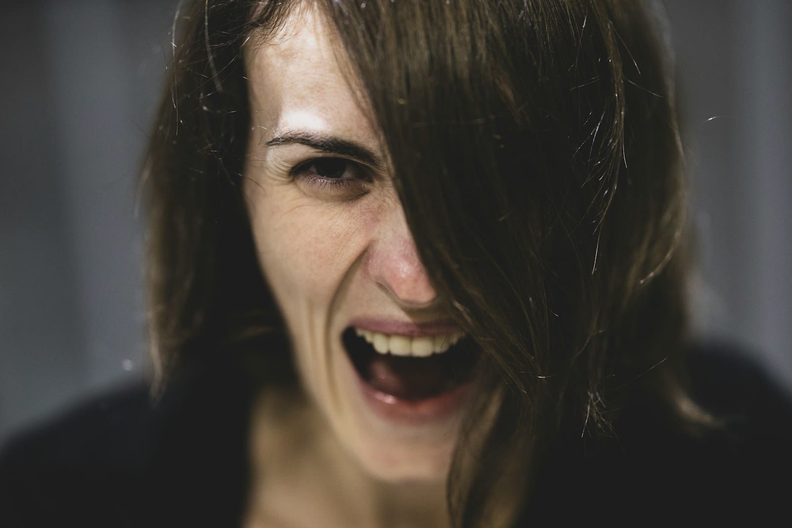 Photo by engin akyurt woman with black hair. She is angry. During Perimenopause relationships can suffer.