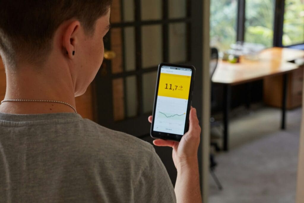 a person looking at blood sugar results on their phone from their continuous glucose monitor 