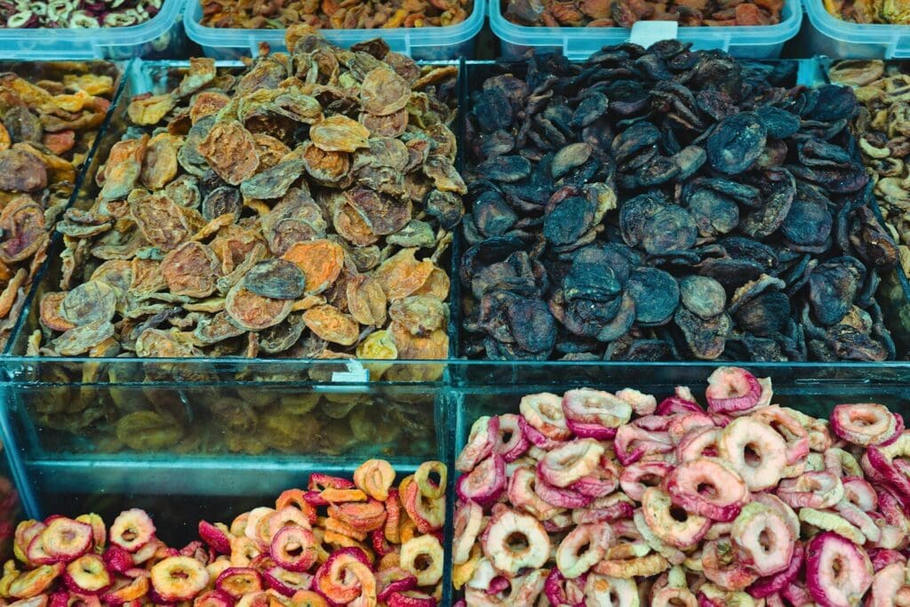 Assortment of dried fruits in market stalls.