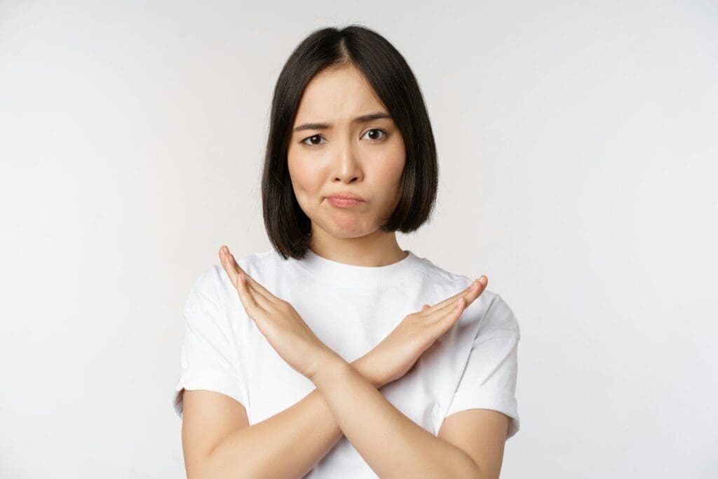 a woman with her hands folded over her chest like an X. She's saying NO to PMS!
