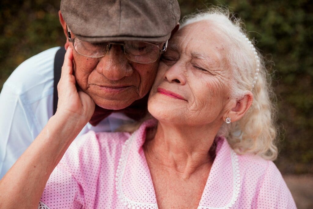 An older couple is embracing each other. social connection is a key to preventing dementia.