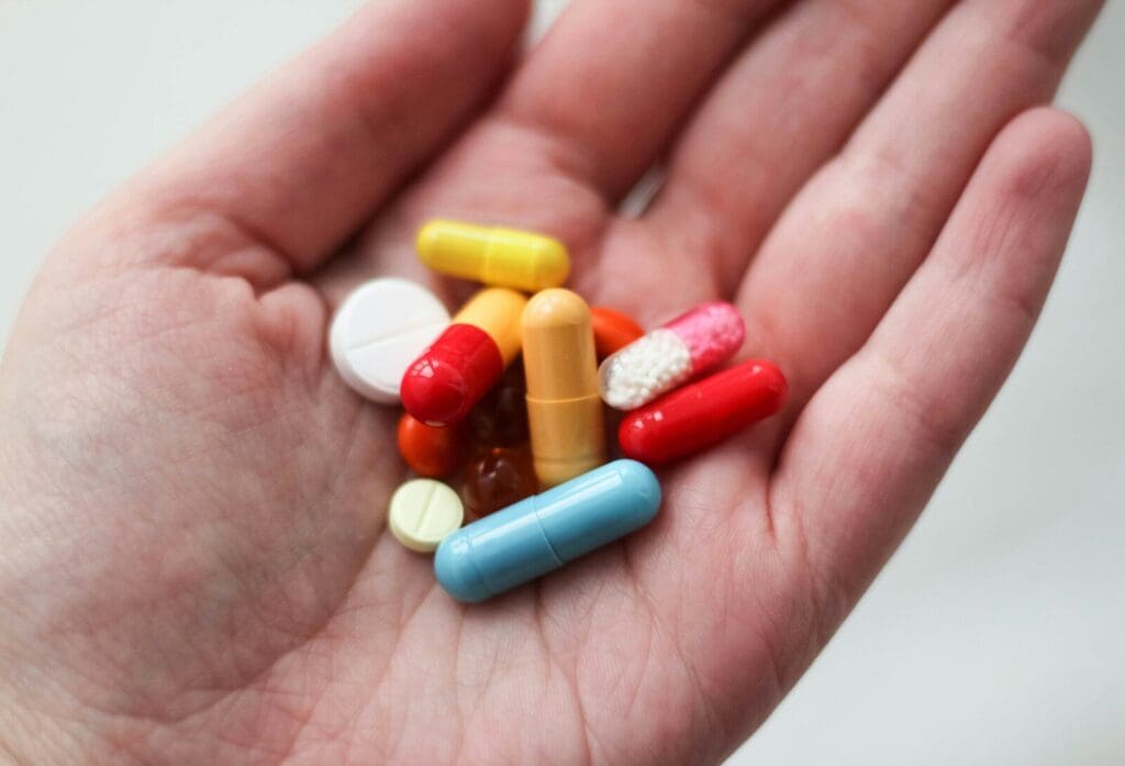 various pills in a person's hand