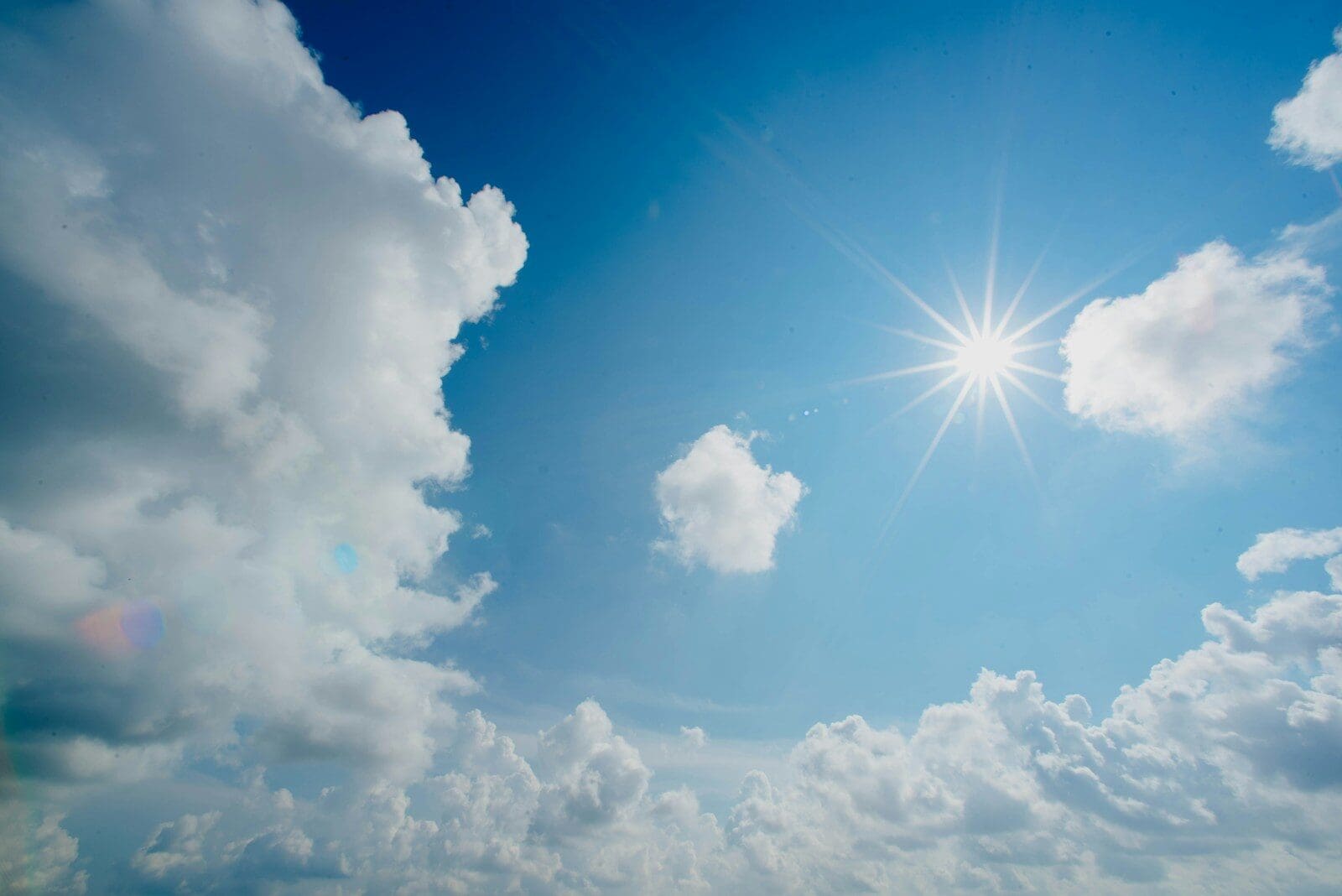 white and blue cloudy sky. A sunny sky can give you vitamin D but also skin cancer!