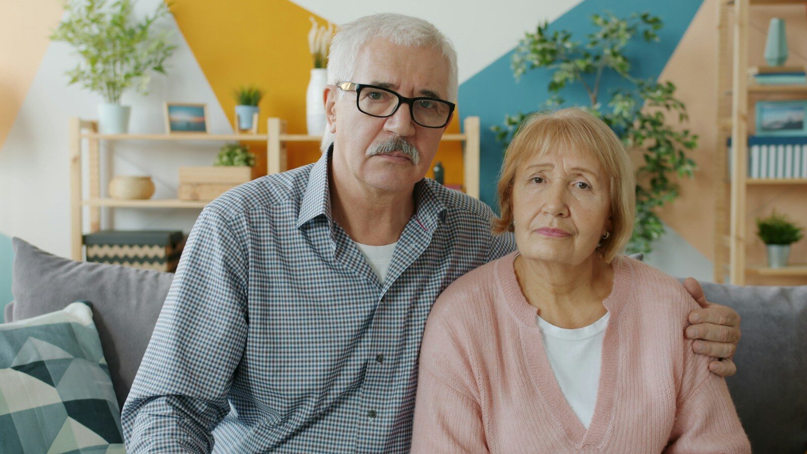 Photo by Vitaly Gariev Elderly couple sitting on a couch indoors looking somber. Dementia is not inevitable. You can fight back.