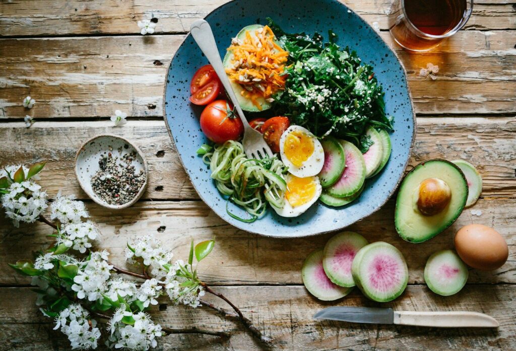 poached egg with vegetables and avocados and tomatoes on blue plate. The Mediterranean diet is one of the most studied diets for preventing dementia.